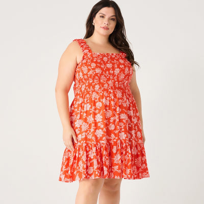 Curvy woman wearing a smocked dress with a bottom ruffle 