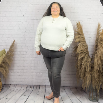 Plus size woman wearing a pebbled grey waffle henley 
