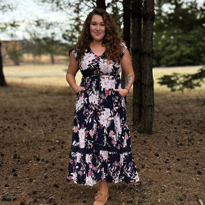 Woman wearing a comfortable floral tiered maxi dress 