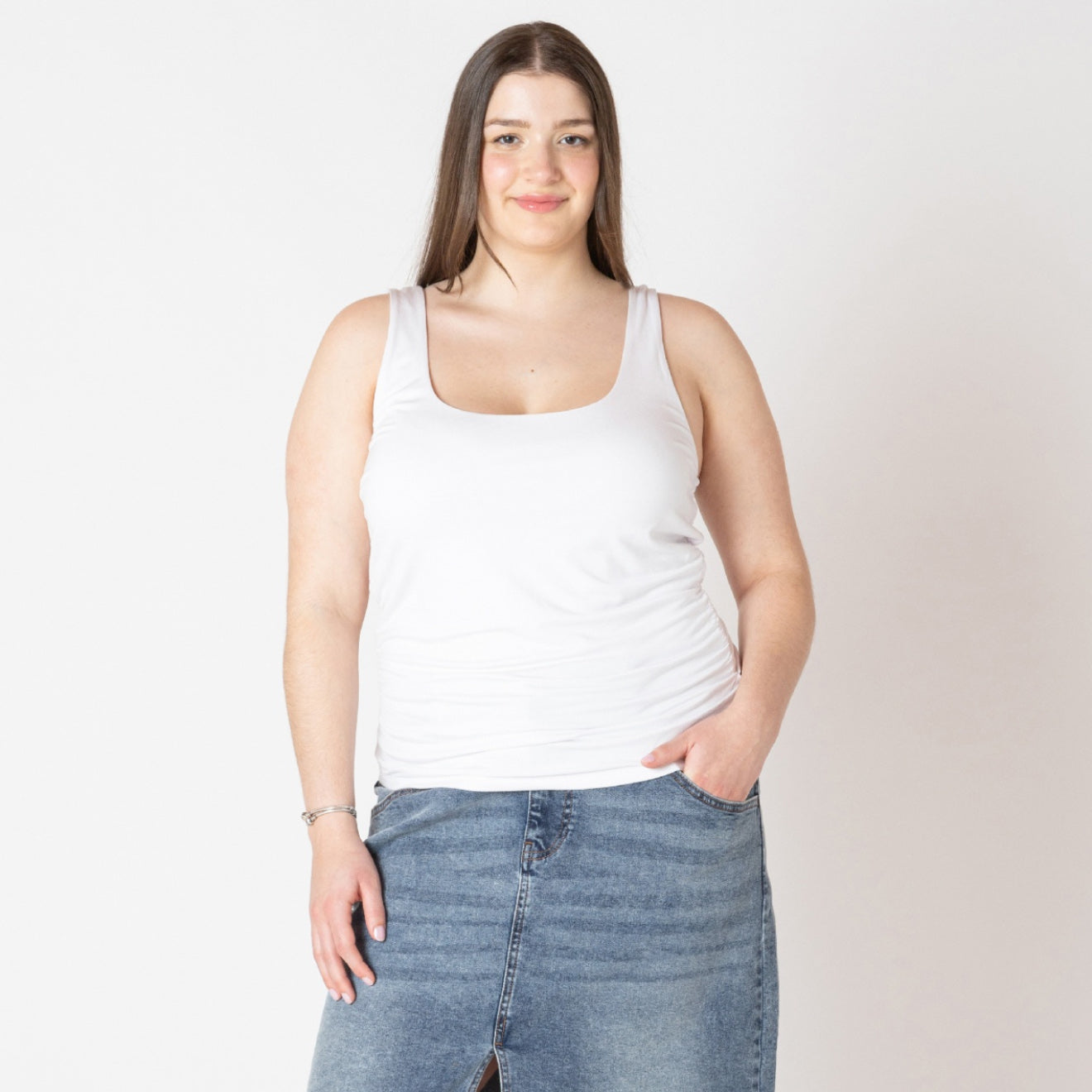 Curvy woman wearing the Dex Essential tank in white 