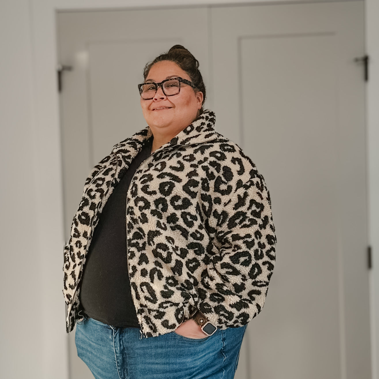 Plus size woman wearing the tan leopard Sherpa jacket from Brunette the Label 