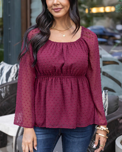 Cute and comfortable wine colored peplum top with Swiss dots 