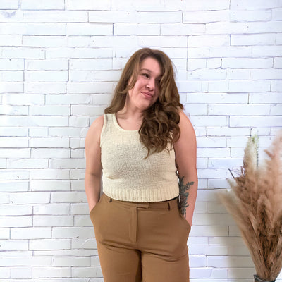 Woman wearing a comfortable and slightly cropped light birch coloured mesh knit tank top 