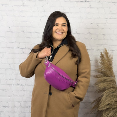 woman wearing a trendy vegan leather.crossbody bag 