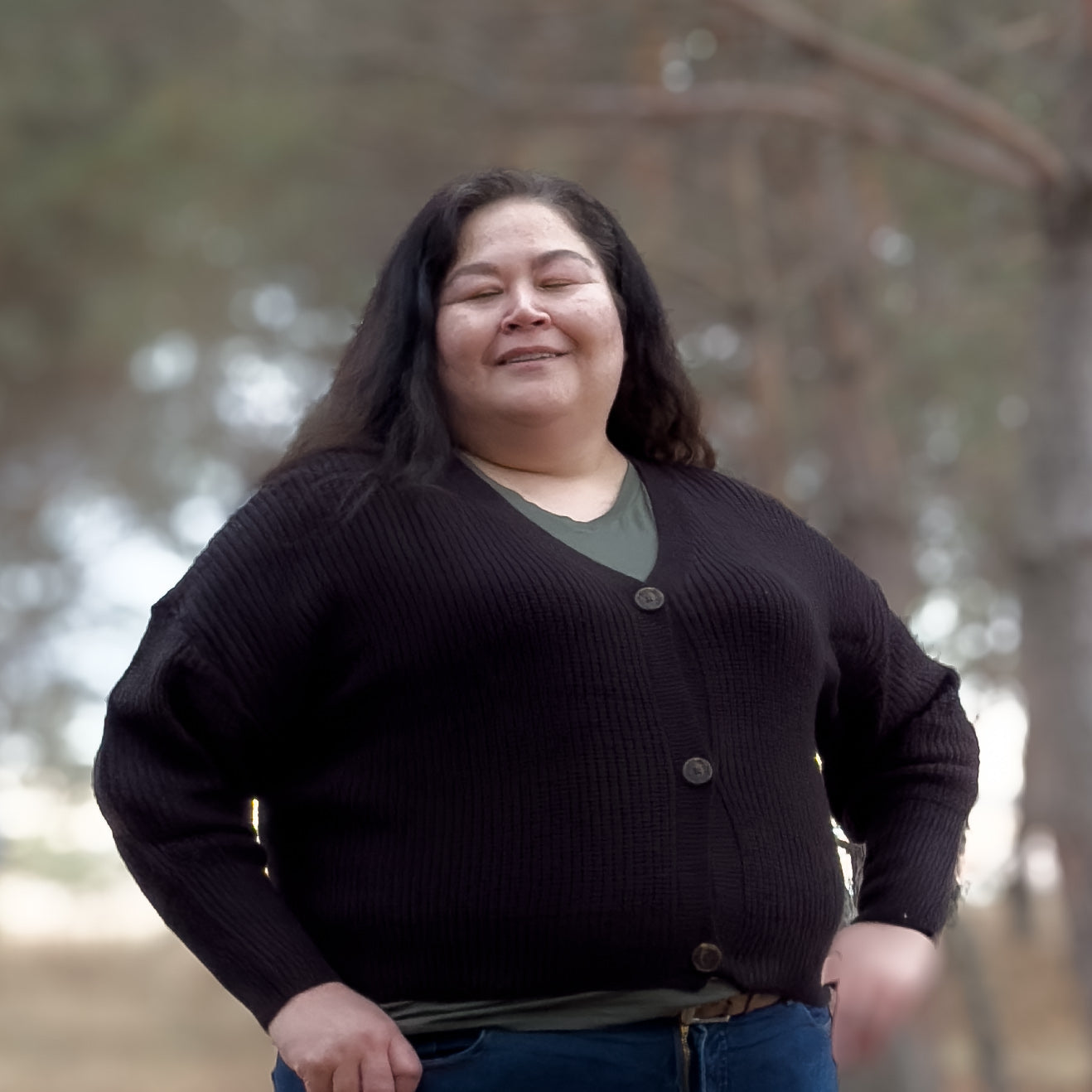 Plus sized woman wearing a black V-necked knit cardigan 
