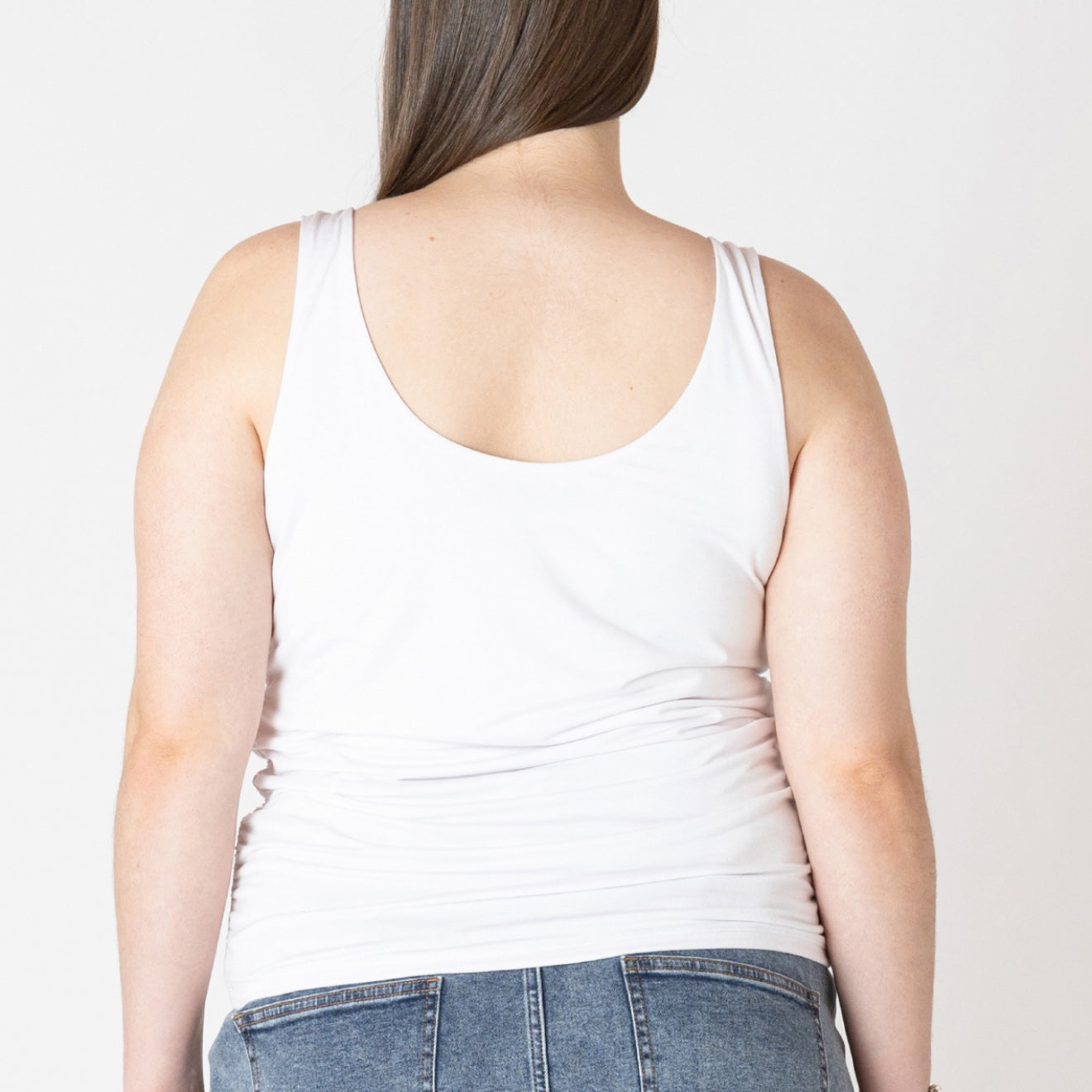 Plus size Woman wearing the Dex Essential tank in white 