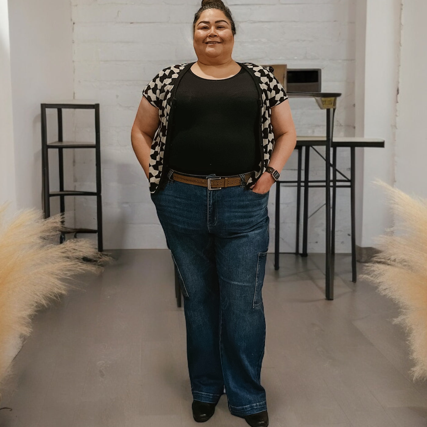 Plus size woman wearing wide legged trendy and comfortable cargo jeans by Judy Blue featuring a dark vintage denim 