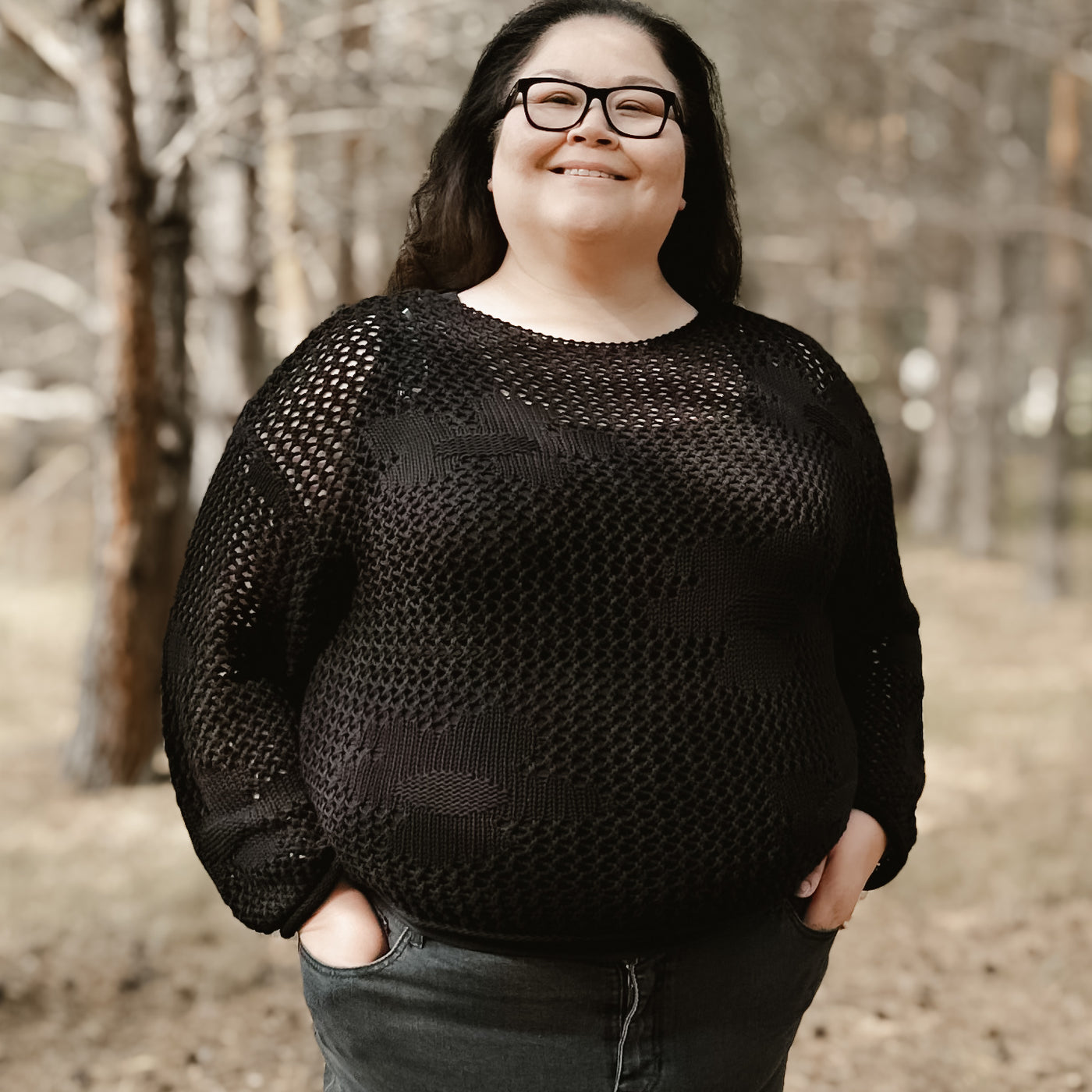 Curvy plus sized woman wearing a trendy black open knit floral crochet sweater by dex 