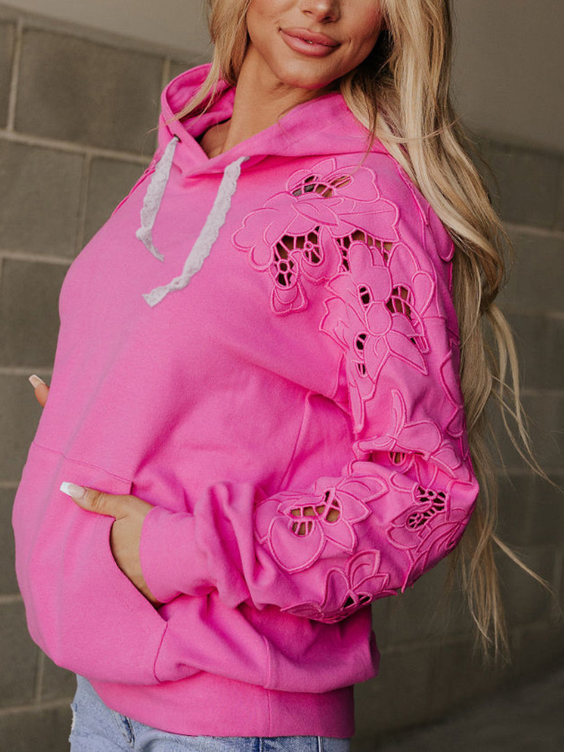 Hot pink hoodie with cutout lace detail on sleeves 