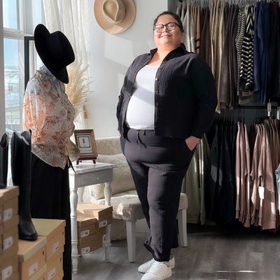 Curvy woman wearing a black cotton gauze textured button up shirt 