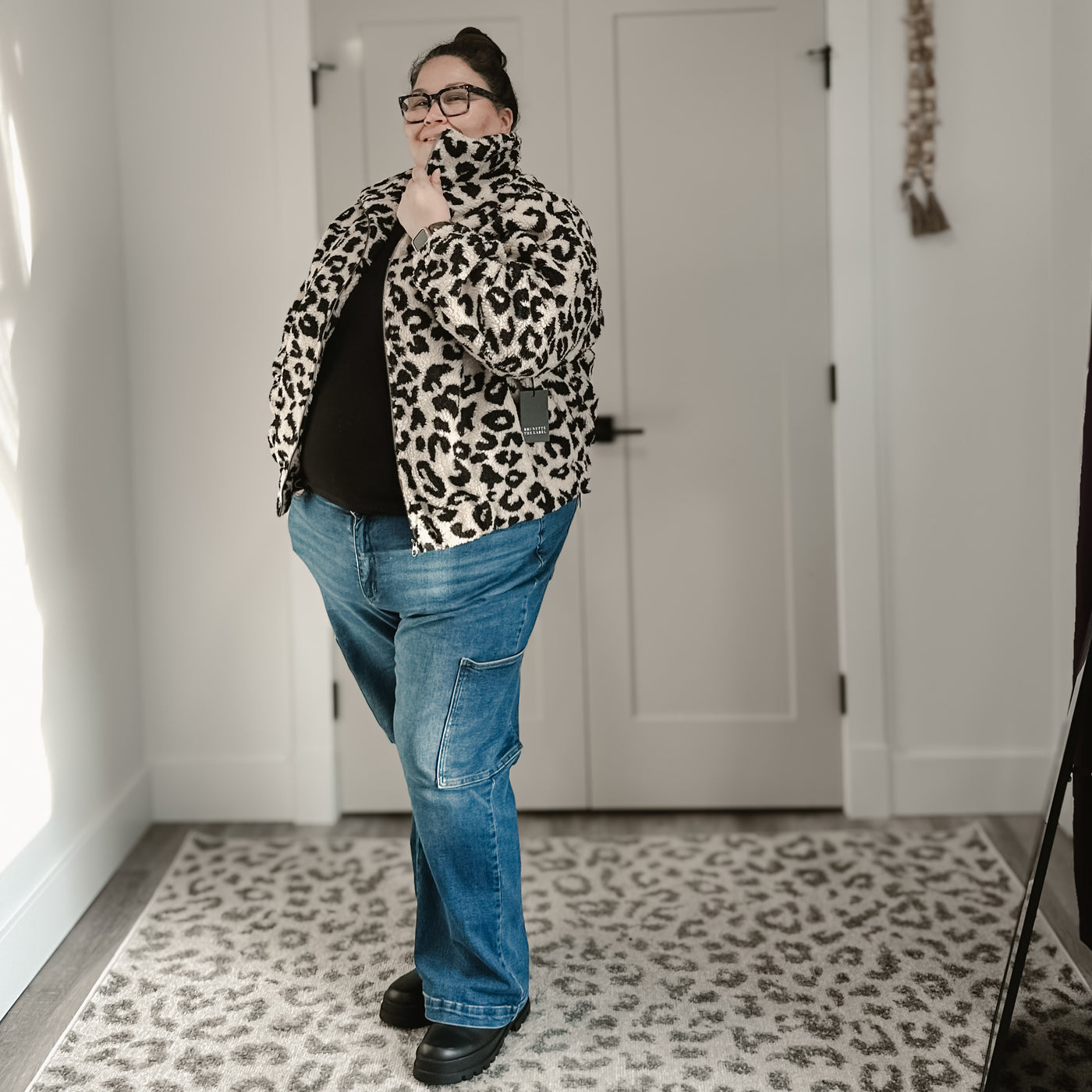 Plus size woman wearing a trendy tan leopard Sherpa jacket 