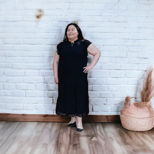 Woman wearing a lightweight and comfortable tiered black maxi dress 