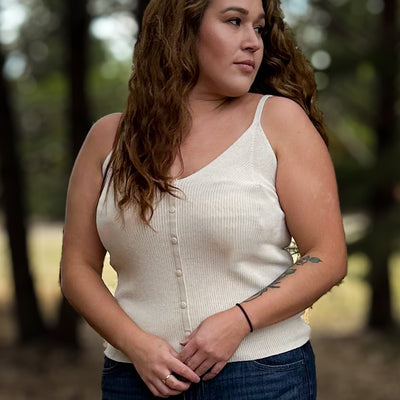 Woman wearing a thin strapped comfortable knit tank with a V neck and buttons in the color birch 