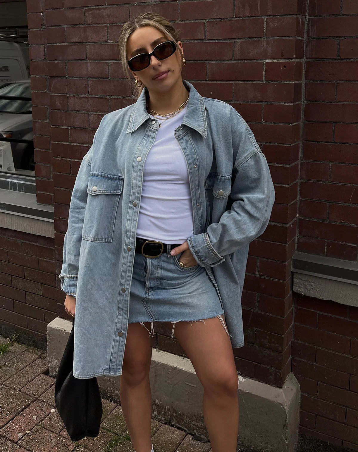 Woman wearing the Shania Denim Jacket in light denim from Brunette the Label 