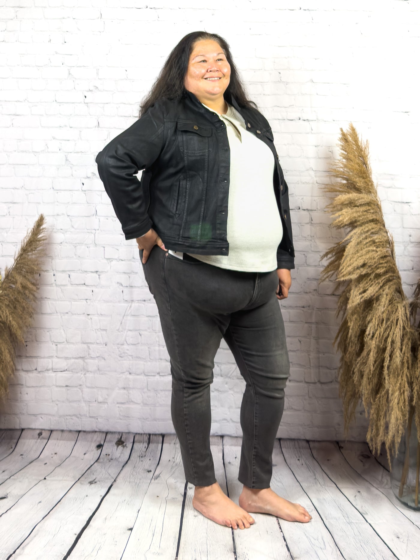 plus sized woman wearing a trendy black coated denim jacket