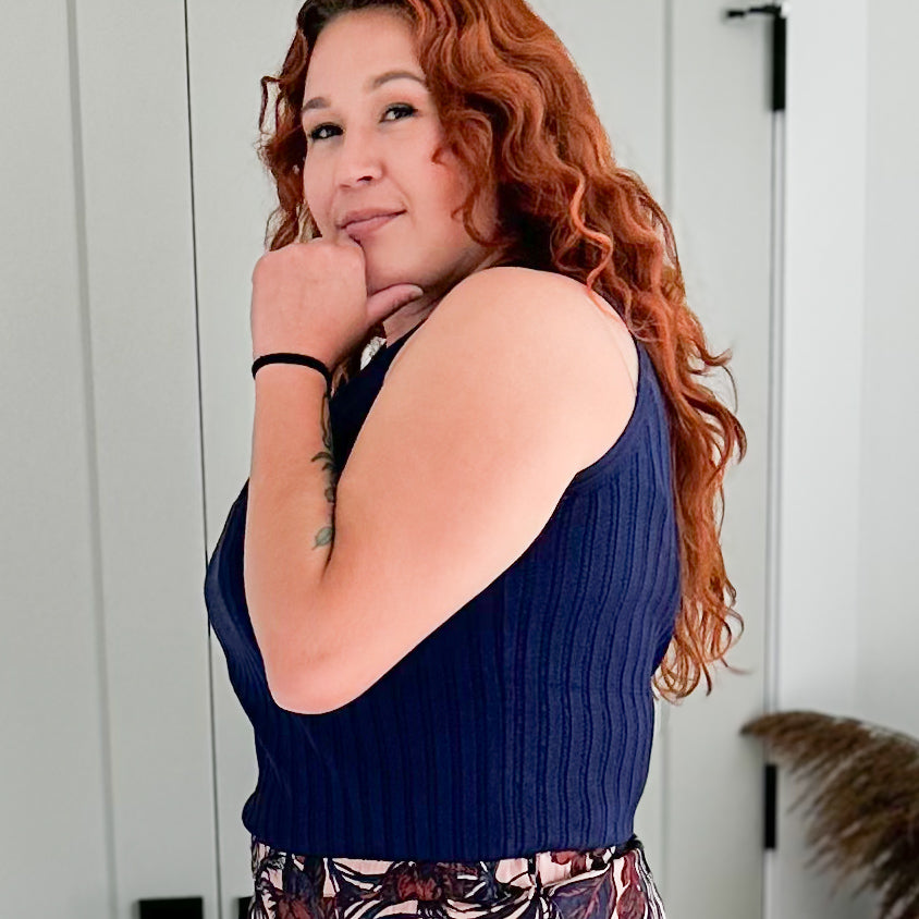 Curvy woman wearing an indigo coloured pointelle tank 