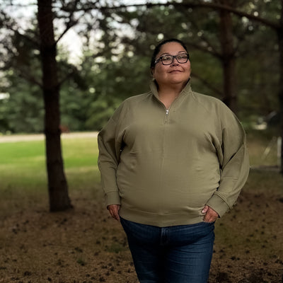 Plus size woman wearing a comfortable and cute half zip sweatshirt in the color olive 