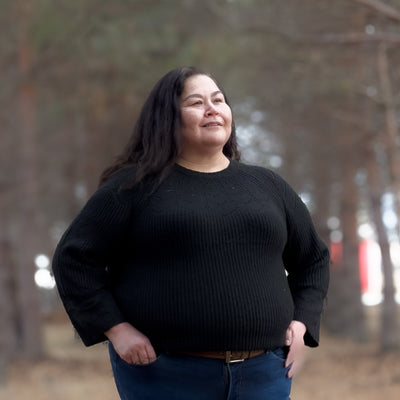 Plus sized woman in a black soft and Comfortable knit sweater 