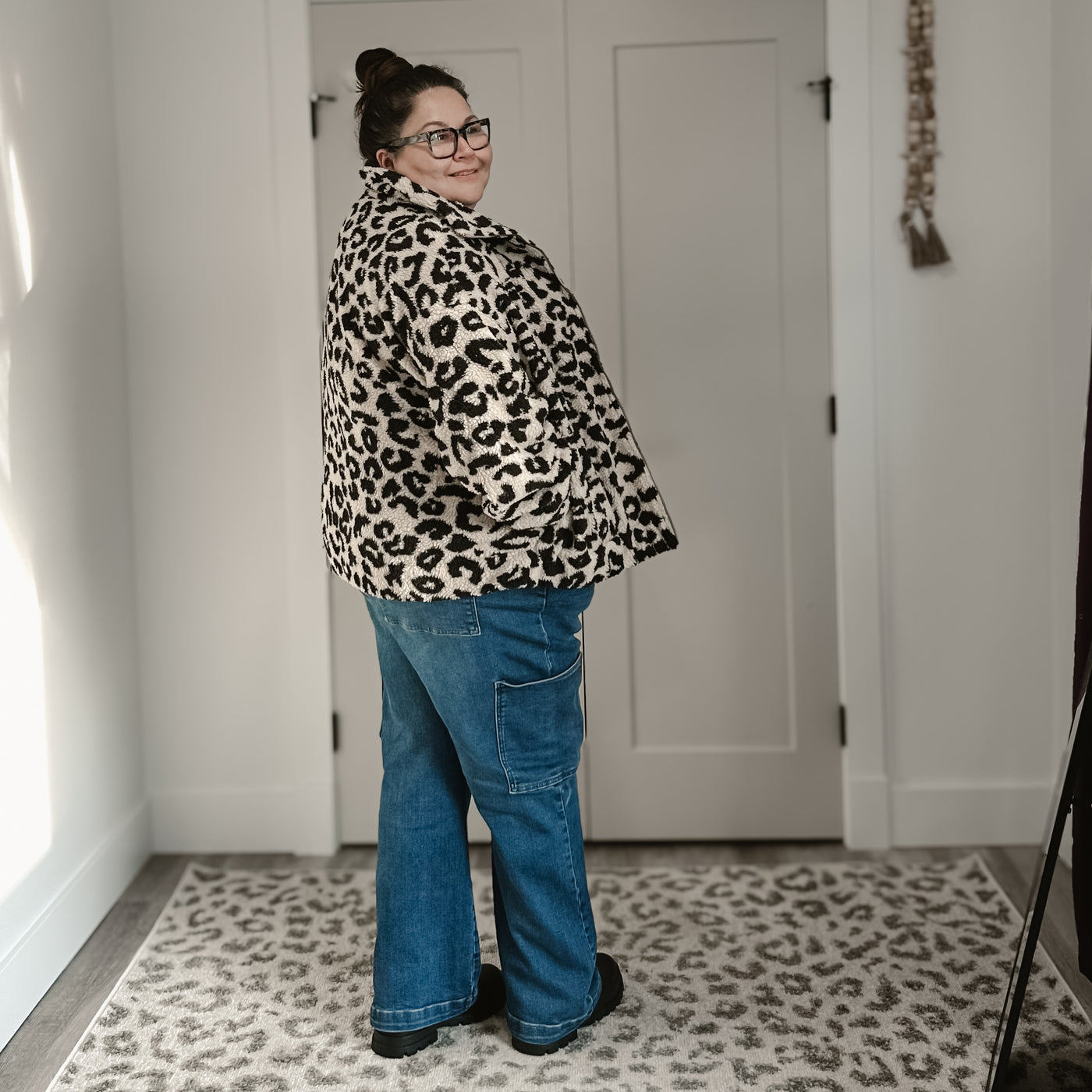 Curvy woman wearing a trendy cute and comfortable tan leopard Sherpa jacket 