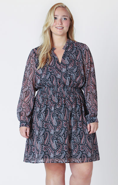 Curvy woman wearing a smocked waist paisley colored mini dress 