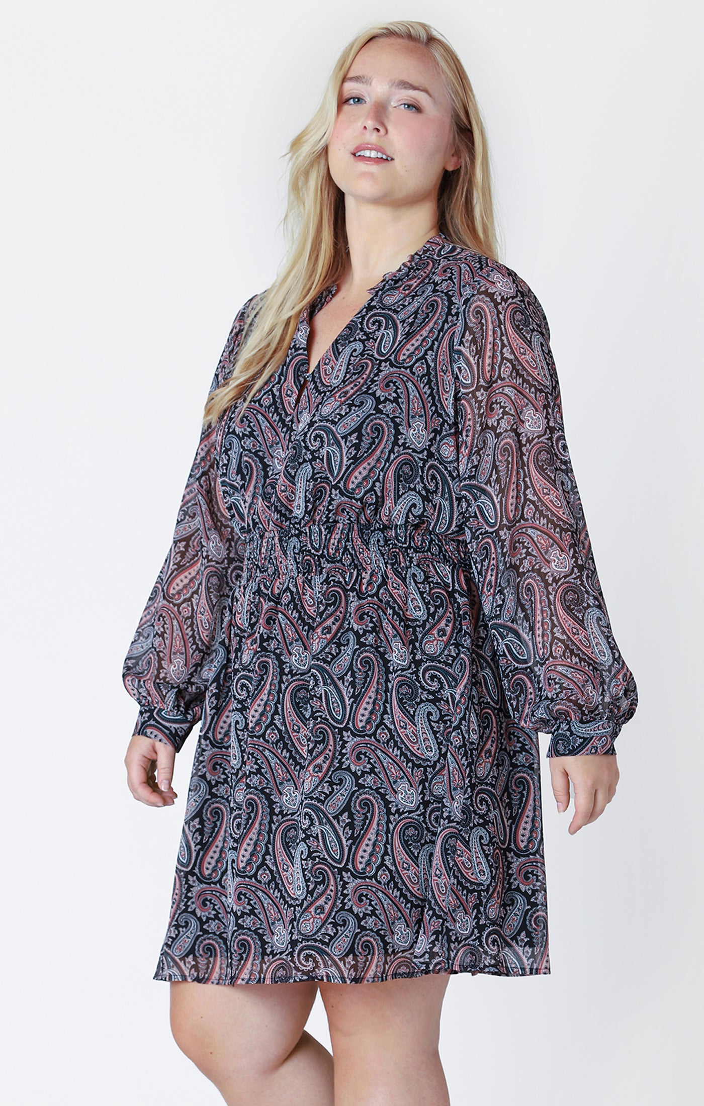 Plus sized long sleeve mini dress with a smocked waist and long sleeves. 
