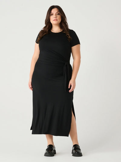 Plus size woman wearing a trendy cute and comfortable midi dress with short sleeves side slits midi length and a waist flattering knot 