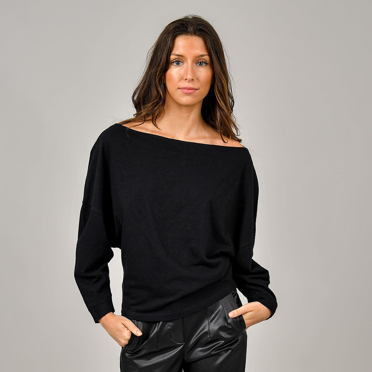 Woman wearing the Briana Boatneck top in black 